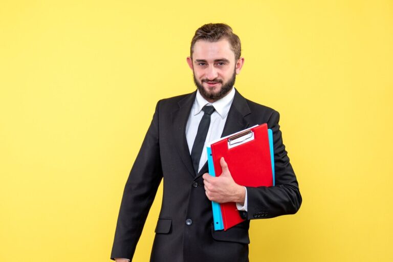 front-view-young-man-black-suit-holding-red-clipboard-blue-folder-smiling-yellow_179666-1765